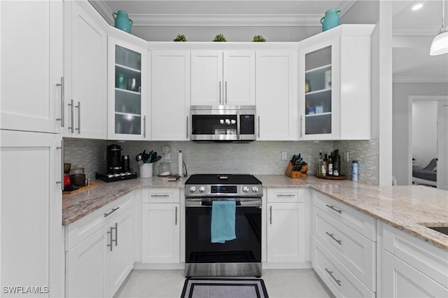 2642 10th Ave NE, Naples, FL 34120 - kitchen with appliances with stainless steel finishes, ornamental molding, white cabinets, tasteful backsplash, and light stone countertops