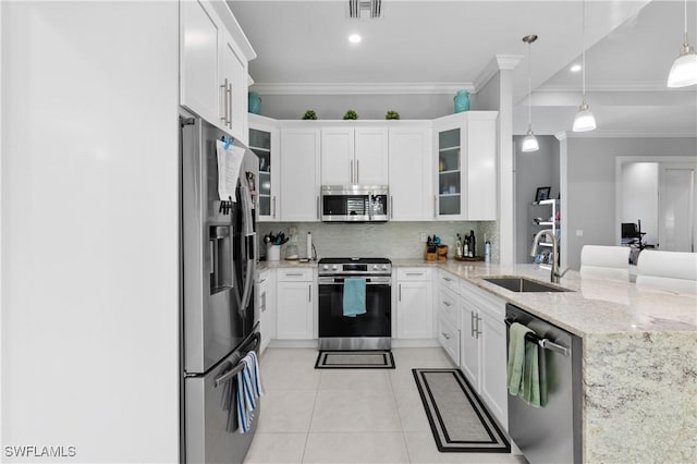 2642 10th Ave NE, Naples, FL 34120 - kitchen featuring appliances with stainless steel finishes, ornamental molding, backsplash, light tile patterned floors, and light stone countertops