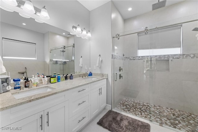 2642 10th Ave NE, Naples, FL 34120 - bathroom featuring a stall shower, double vanity, and recessed lighting