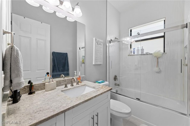 2642 10th Ave NE, Naples, FL 34120 - full bathroom featuring vanity and combined bath / shower with glass door