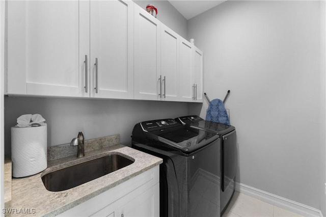 2642 10th Ave NE, Naples, FL 34120 - laundry room with independent washer and dryer, cabinet space, and light tile patterned flooring