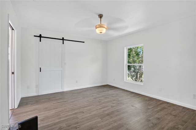 1905 SW 11th St, Cape Coral, FL 33991 - unfurnished bedroom featuring a barn door, wood finished floors, and ceiling fan
