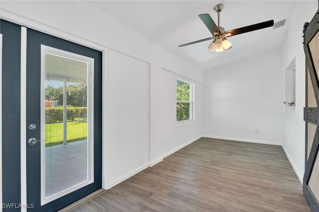 1905 SW 11th St, Cape Coral, FL 33991 - spare room featuring a barn door, lofted ceiling, wood finished floors, and ceiling fan