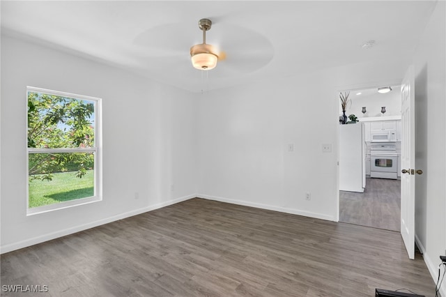 1905 SW 11th St, Cape Coral, FL 33991 - empty room with wood finished floors, ceiling fan, and a smoke detector