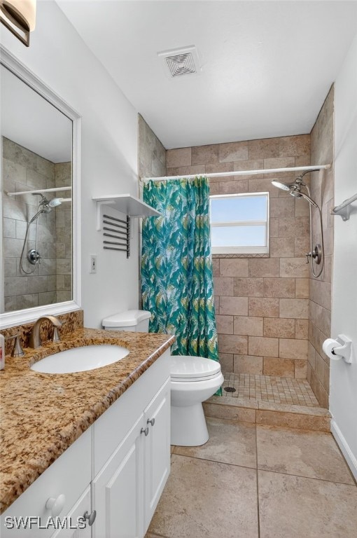 1905 SW 11th St, Cape Coral, FL 33991 - bathroom featuring vanity, a tile shower, and tile patterned flooring