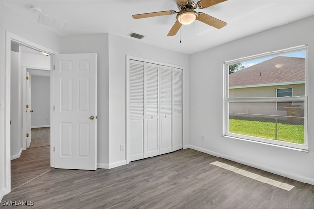 1905 SW 11th St, Cape Coral, FL 33991 - unfurnished bedroom with wood finished floors, a closet, and a ceiling fan