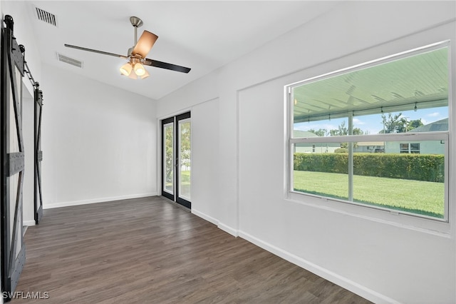 1905 SW 11th St, Cape Coral, FL 33991 - unfurnished room featuring a barn door, dark wood finished floors, and ceiling fan