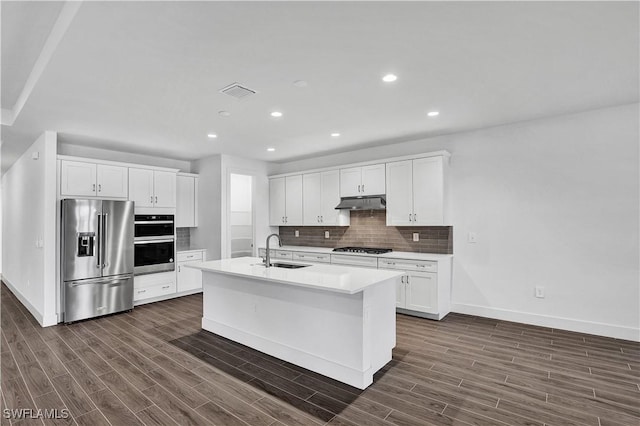 16272 Wax Myrtle St, Punta Gorda, FL 33982 - kitchen featuring appliances with stainless steel finishes, tasteful backsplash, dark wood-style flooring, under cabinet range hood, and recessed lighting