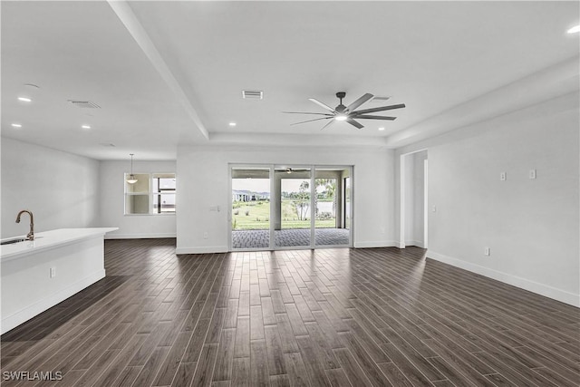 16272 Wax Myrtle St, Punta Gorda, FL 33982 - unfurnished living room featuring a ceiling fan, a tray ceiling, dark wood-style flooring, and recessed lighting