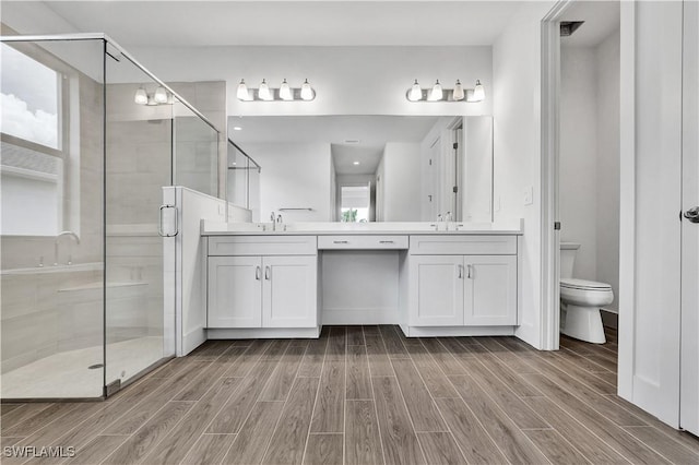 16272 Wax Myrtle St, Punta Gorda, FL 33982 - full bathroom with wood finished floors, double vanity, and a shower stall