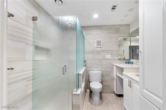 18381 Panther Trail Ln, North Fort Myers, FL 33917 - full bath featuring vanity, a stall shower, tile walls, and recessed lighting