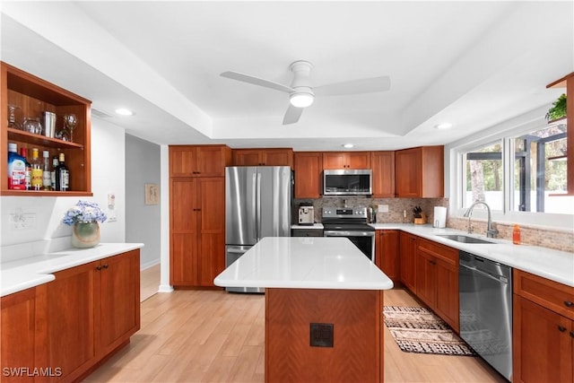 18381 Panther Trail Ln, North Fort Myers, FL 33917 - kitchen featuring appliances with stainless steel finishes, a tray ceiling, light wood finished floors, light countertops, and recessed lighting
