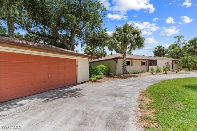 18381 Panther Trail Ln, North Fort Myers, FL 33917 - ranch-style house featuring a garage, stucco siding, and driveway