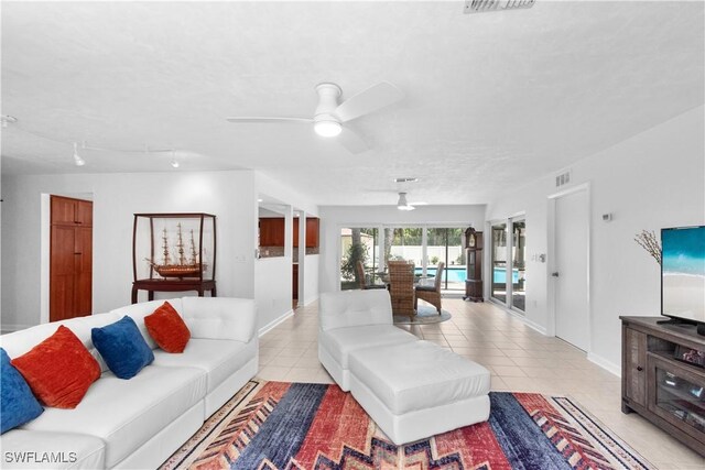 18381 Panther Trail Ln, North Fort Myers, FL 33917 - living area featuring a ceiling fan, light tile patterned floors, and french doors