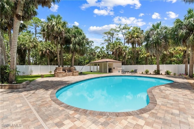 18381 Panther Trail Ln, North Fort Myers, FL 33917 - view of pool with a patio, a fenced backyard, and view of wooded area