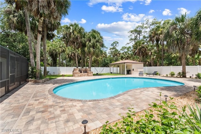 18381 Panther Trail Ln, North Fort Myers, FL 33917 - view of swimming pool with a fenced backyard, a patio, and view of wooded area