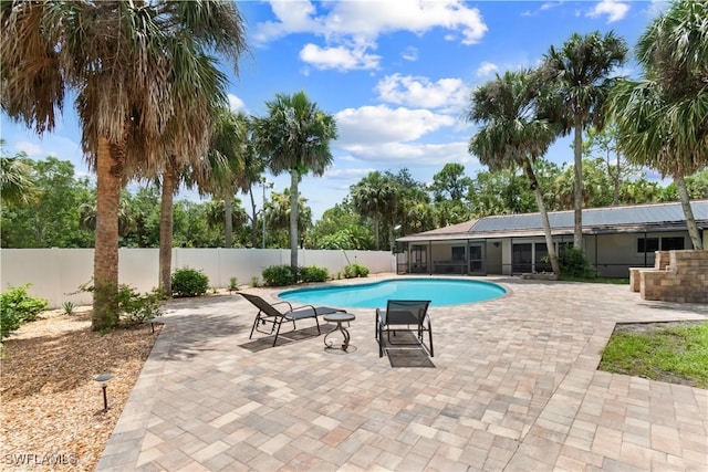 18381 Panther Trail Ln, North Fort Myers, FL 33917 - view of pool with a fenced backyard, a patio area, and a sunroom
