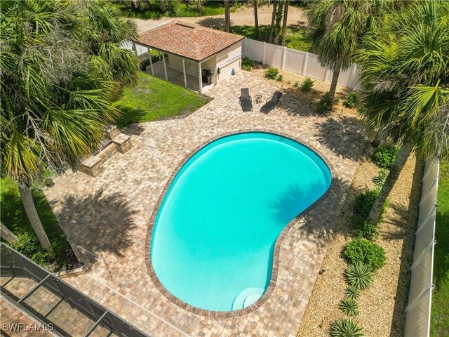 18381 Panther Trail Ln, North Fort Myers, FL 33917 - view of swimming pool featuring a fenced backyard, a patio, and an outbuilding