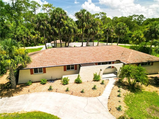 18381 Panther Trail Ln, North Fort Myers, FL 33917 - view of front facade featuring stucco siding and view of wooded area