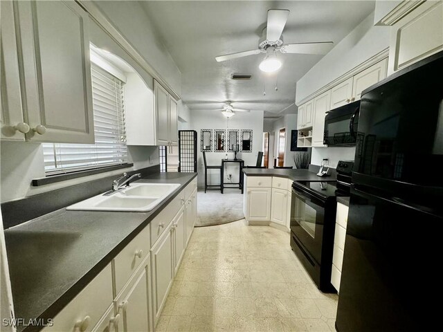 1427 Charles Rd, Fort Myers, FL 33919 - kitchen featuring black appliances, a ceiling fan, dark countertops, a peninsula, and white cabinetry
