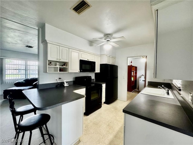 1427 Charles Rd, Fort Myers, FL 33919 - kitchen featuring black appliances, dark countertops, a ceiling fan, a kitchen breakfast bar, and a peninsula