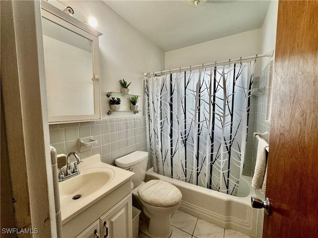 1427 Charles Rd, Fort Myers, FL 33919 - bathroom with shower / bath combo with shower curtain, vanity, tile patterned flooring, tile walls, and a wainscoted wall