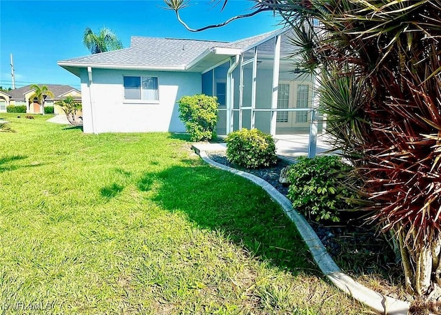 4619 SW 20th Pl, Cape Coral, FL 33914 - view of side of property with stucco siding, a yard, glass enclosure, and a shingled roof