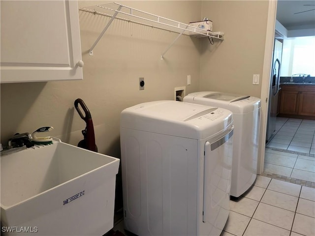 4619 SW 20th Pl, Cape Coral, FL 33914 - laundry area with cabinet space, washer and dryer, and light tile patterned floors