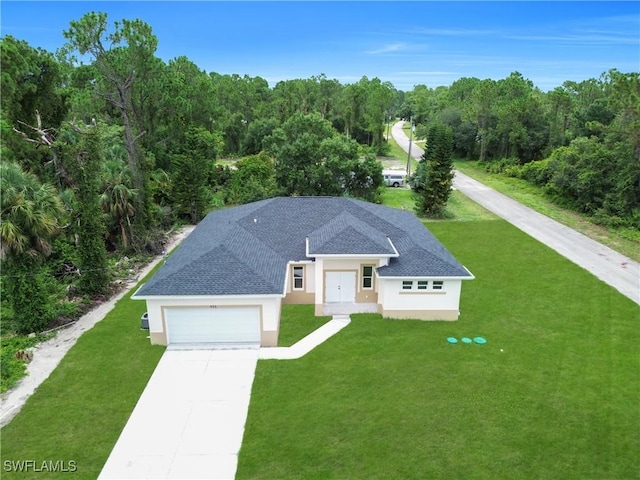 933 Anthony St E, Lehigh Acres, FL 33974 - view of front of home with stucco siding, driveway, an attached garage, and a front yard