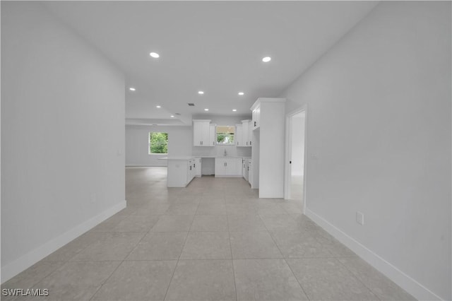 933 Anthony St E, Lehigh Acres, FL 33974 - unfurnished living room with recessed lighting and light tile patterned floors