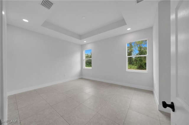 933 Anthony St E, Lehigh Acres, FL 33974 - spare room with light tile patterned floors, recessed lighting, and a tray ceiling