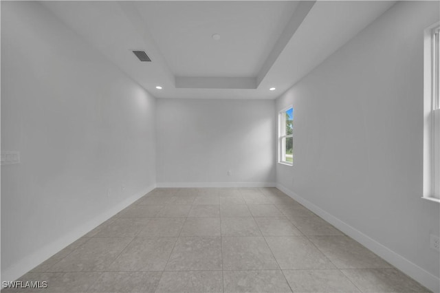 933 Anthony St E, Lehigh Acres, FL 33974 - unfurnished room with recessed lighting, light tile patterned floors, and a tray ceiling