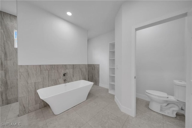 933 Anthony St E, Lehigh Acres, FL 33974 - full bath with a freestanding bath, tile walls, tile patterned flooring, and recessed lighting