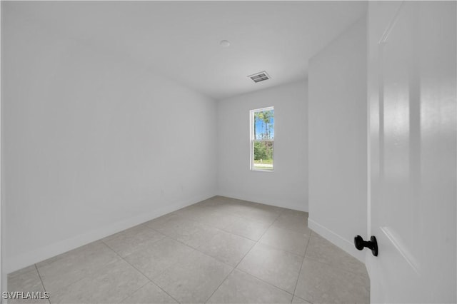 933 Anthony St E, Lehigh Acres, FL 33974 - empty room featuring light tile patterned floors and baseboards