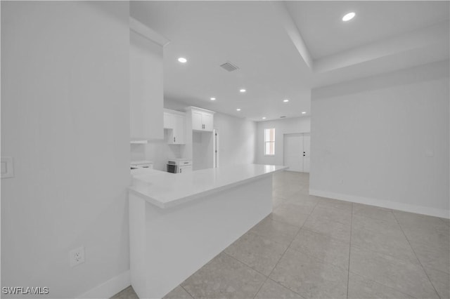 933 Anthony St E, Lehigh Acres, FL 33974 - kitchen with white cabinetry, light countertops, recessed lighting, light tile patterned floors, and a peninsula