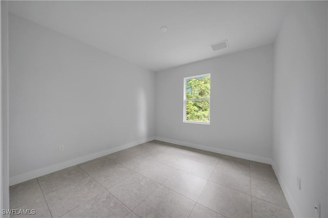 933 Anthony St E, Lehigh Acres, FL 33974 - empty room featuring baseboards and light tile patterned flooring