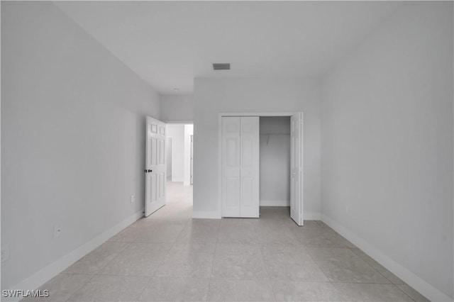 933 Anthony St E, Lehigh Acres, FL 33974 - unfurnished bedroom featuring a closet and light tile patterned floors