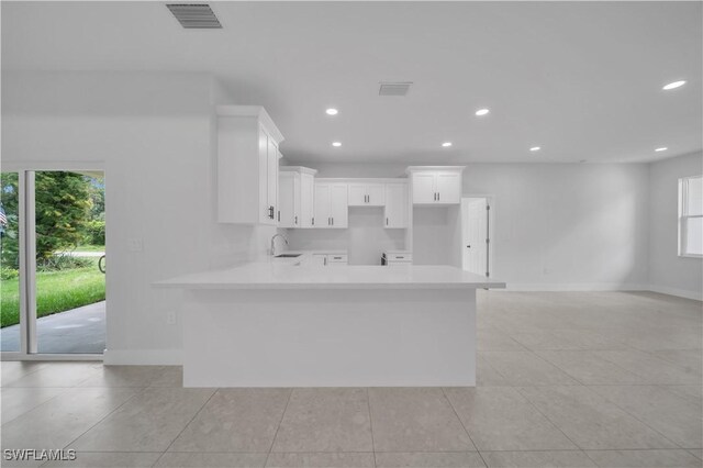 933 Anthony St E, Lehigh Acres, FL 33974 - kitchen featuring light tile patterned flooring, plenty of natural light, white cabinets, and recessed lighting