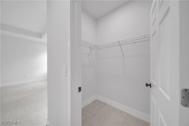 933 Anthony St E, Lehigh Acres, FL 33974 - spacious closet featuring light tile patterned flooring