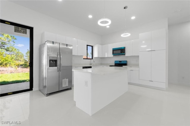 726 Cardinal St E, Lehigh Acres, FL 33974 - kitchen with stainless steel refrigerator with ice dispenser, black microwave, electric range, modern cabinets, and white cabinets