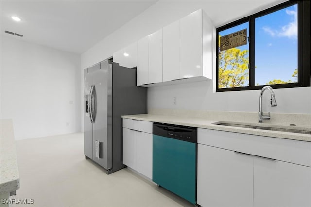 726 Cardinal St E, Lehigh Acres, FL 33974 - kitchen with dishwasher, light countertops, white cabinets, and recessed lighting