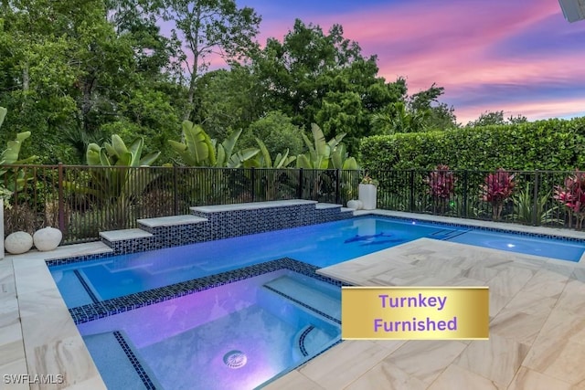 3829 Helmsman Dr, Naples, FL 34120 - pool at dusk with a pool with connected hot tub