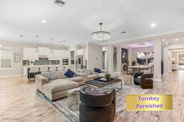 3829 Helmsman Dr, Naples, FL 34120 - living area with a chandelier, crown molding, recessed lighting, and light wood-type flooring