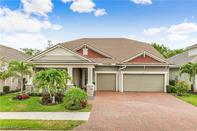 3829 Helmsman Dr, Naples, FL 34120 - craftsman inspired home featuring decorative driveway, stucco siding, a garage, a front yard, and a tile roof