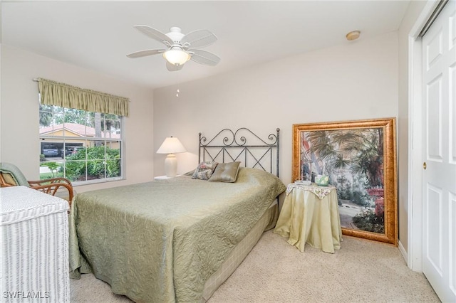 9322 Aegean Cir, Lehigh Acres, FL 33936 - bedroom with light colored carpet and ceiling fan