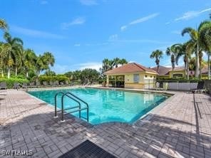 9322 Aegean Cir, Lehigh Acres, FL 33936 - community pool featuring a patio