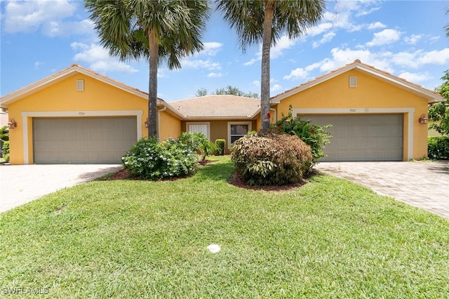9322 Aegean Cir, Lehigh Acres, FL 33936 - ranch-style house with driveway, an attached garage, stucco siding, a front lawn, and a tiled roof