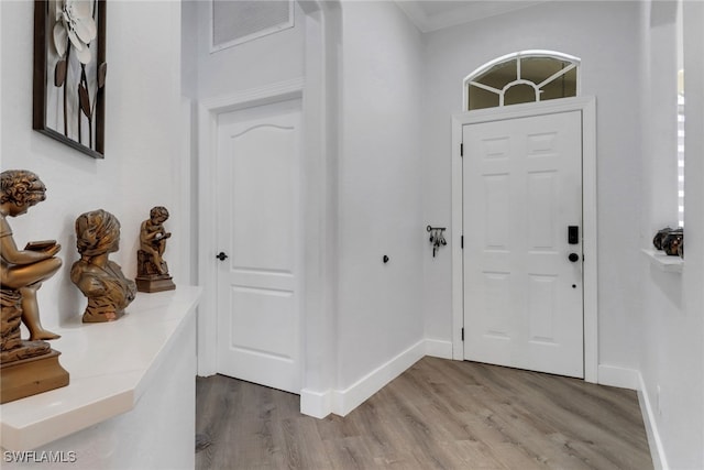 8644 Ibis Cove Cir, Naples, FL 34119 - foyer featuring light wood-style floors and ornamental molding