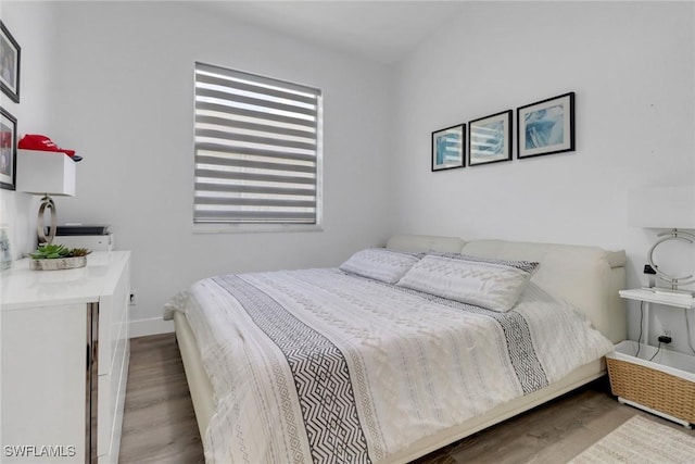 8644 Ibis Cove Cir, Naples, FL 34119 - bedroom with wood finished floors and baseboards