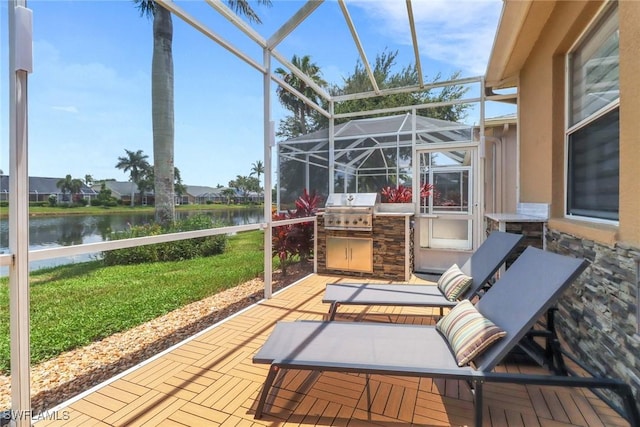 8644 Ibis Cove Cir, Naples, FL 34119 - view of patio / terrace featuring a water view, glass enclosure, and an outdoor kitchen